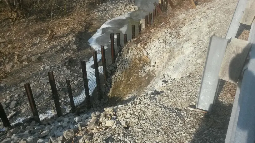 A small stream of water flowing through the ground.