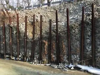 A fence that has been cut down and is being used as a wall.