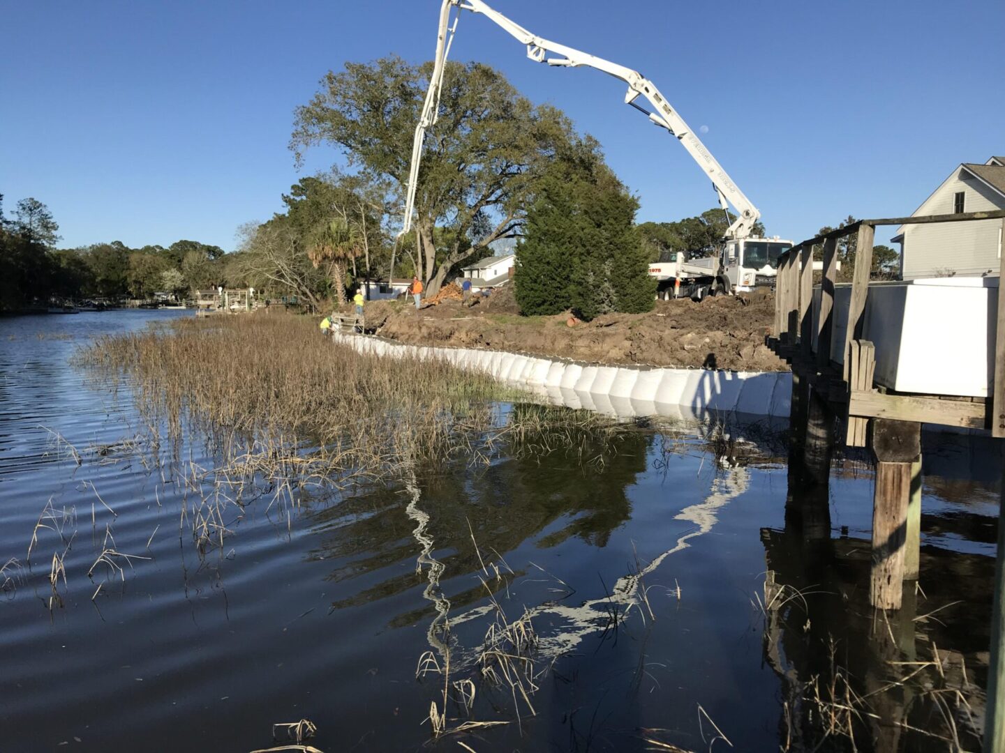 A large white pipe is in the water.