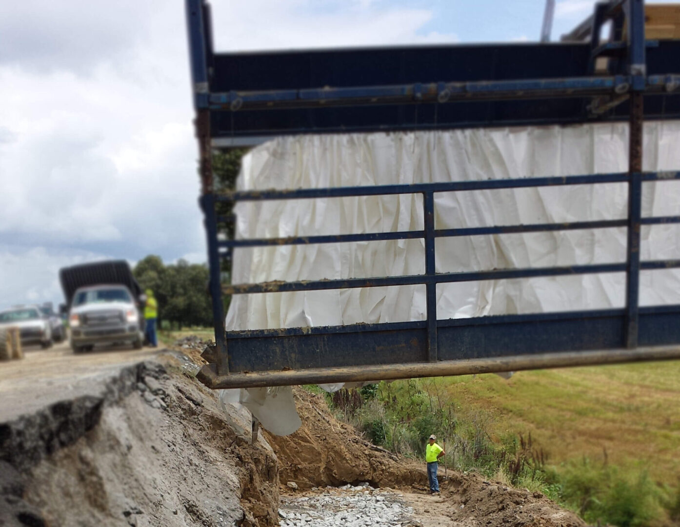 A large truck is driving down the road.