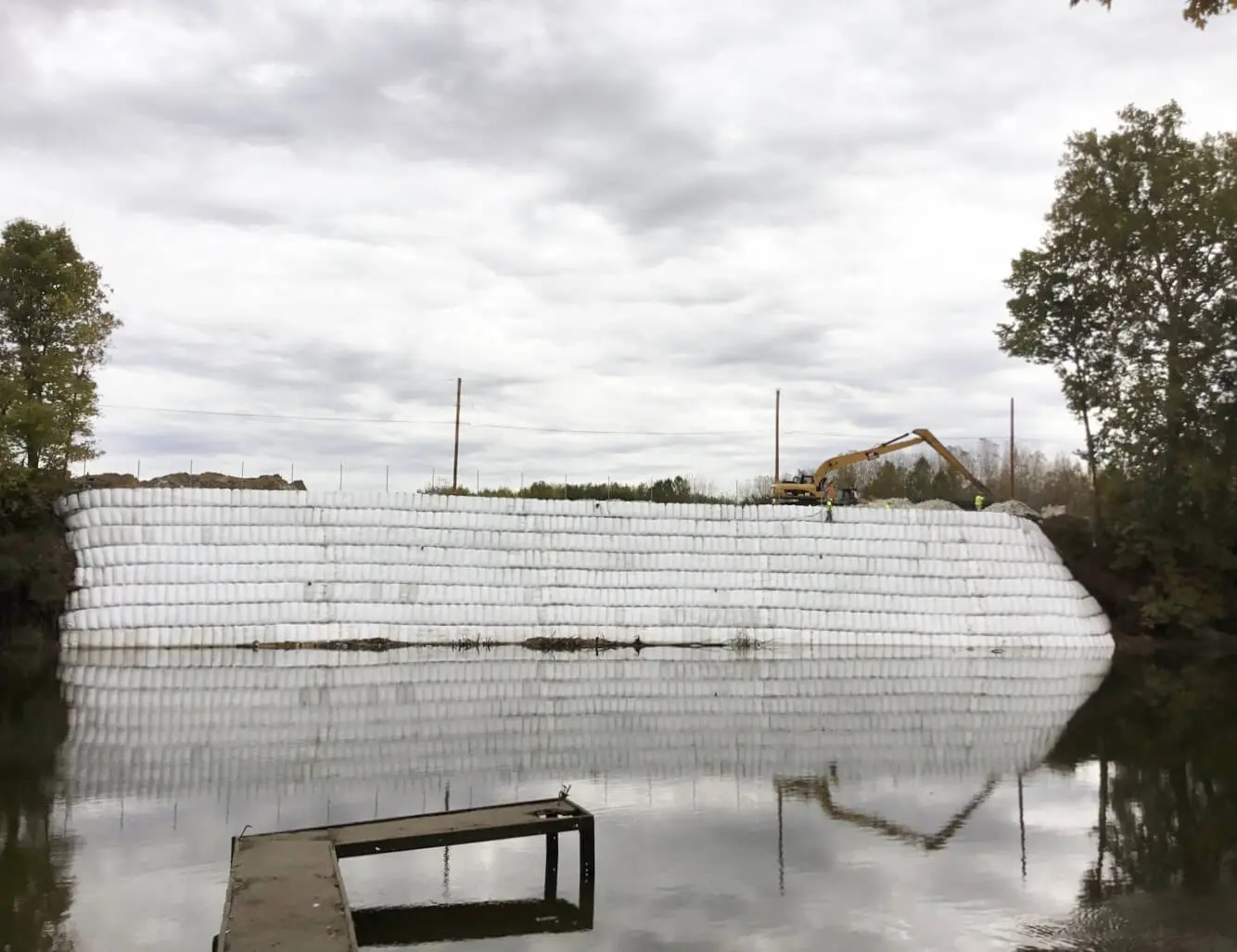 A flooded area with a bench and water